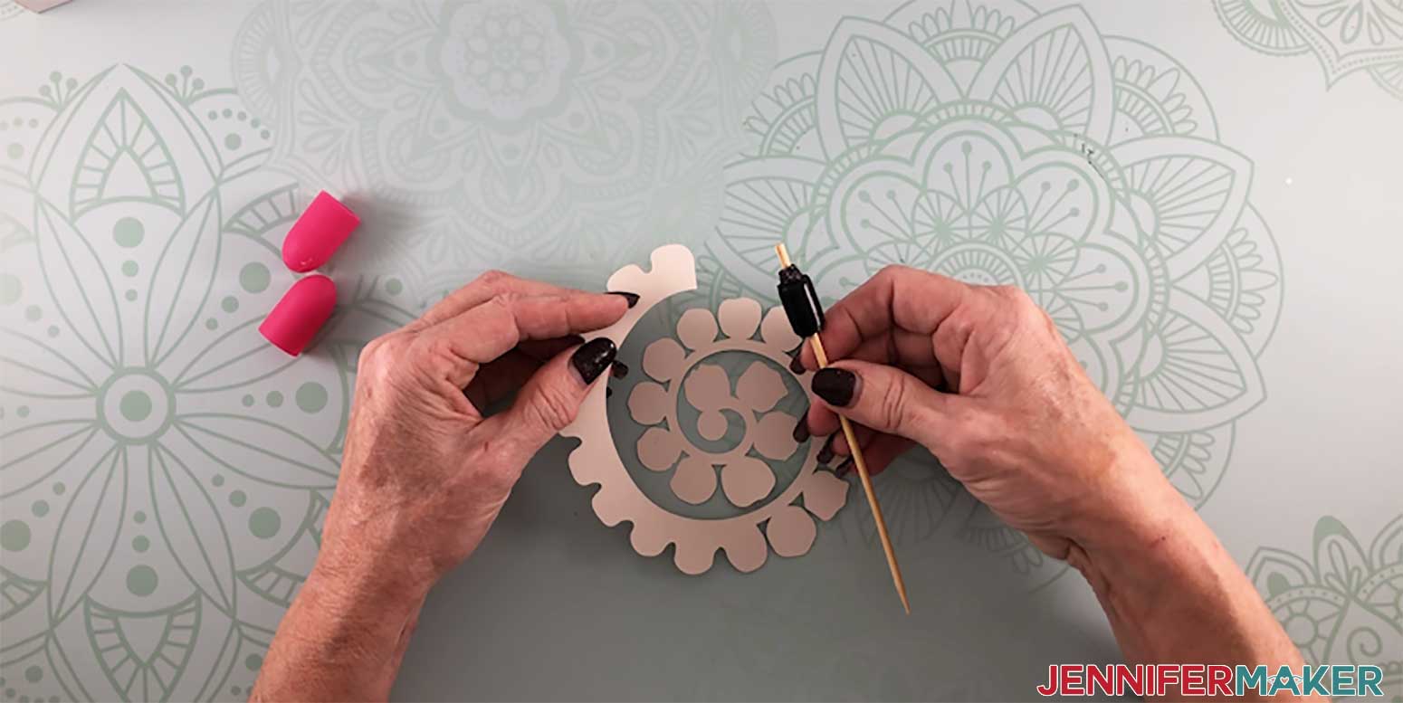 Rolling a paper rose with a DIY quilling tool to make a paper flower shadow box