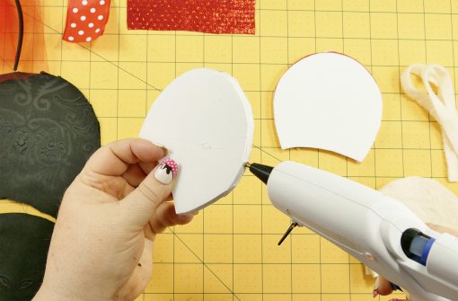 Put hot glue along the outer edge of the foam mouse ear