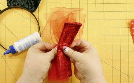 Add some tulle to the bow on the DIY Mouse Ears