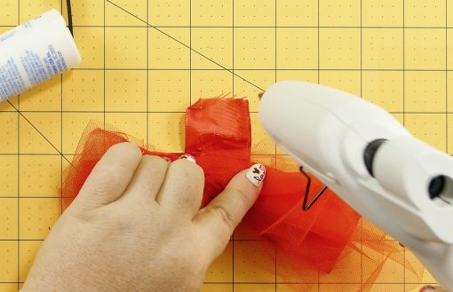 Glue the ribbon to itself on the DIY Mouse Ears