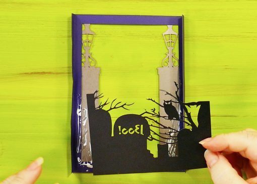 Glue the graveyard layer onto the back of your purple frame on your Halloween card