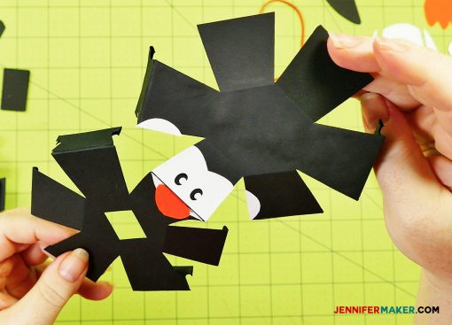 Sandwich the bill in between the top and bottom face pieces of your penguin paper bomb