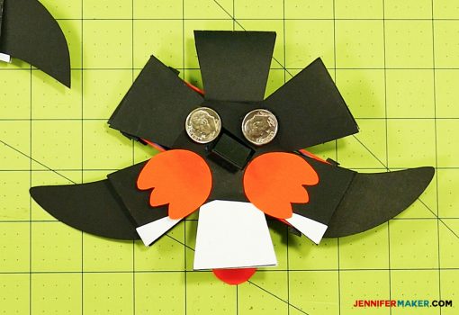 Glue dimes to the bottom of your penguin paper bomb to stabilize his pop ups