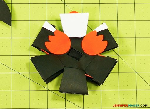 Glue the feet on your penguin paper bomb