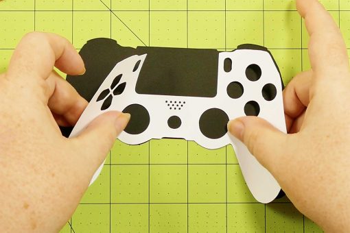 Attach the white controller to the black controller of the popup game controller card