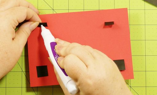 Glue down the tabs for the pop-up game controller card