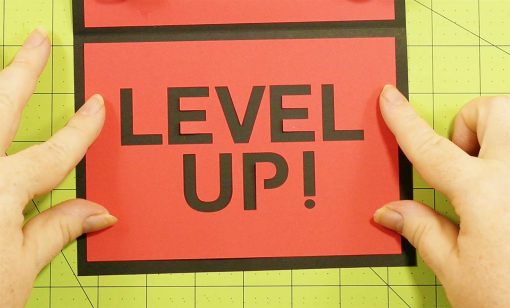 Attach the Level Up! Card to the pop-up game controller card