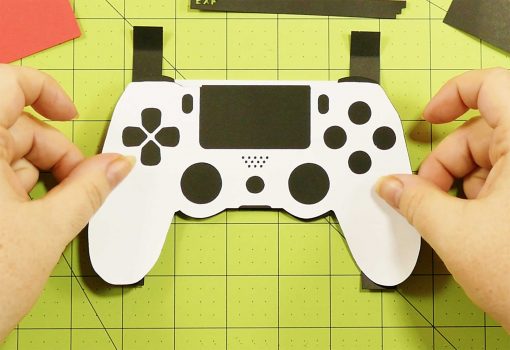 Attach the controller to the pop-up section of the pop-up game controller card