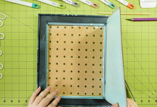 Open up the back of the frame with the pegboard in place