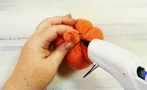 Glue the end of the thread on your sweater pumpkin