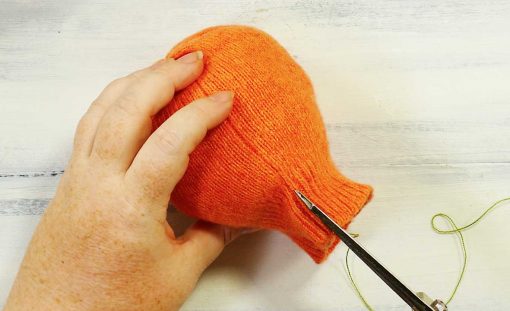 Notch the top edge of your sweater next to the seam