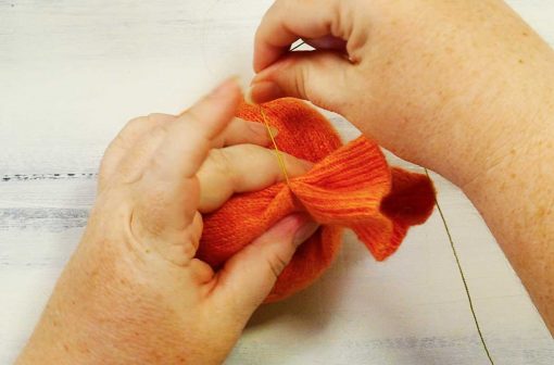 Wrap the thread around the top of your sweater pumpkin