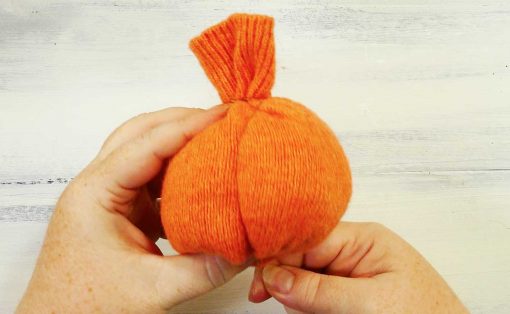 Wrap thread around the sweater pumpkin to create segments