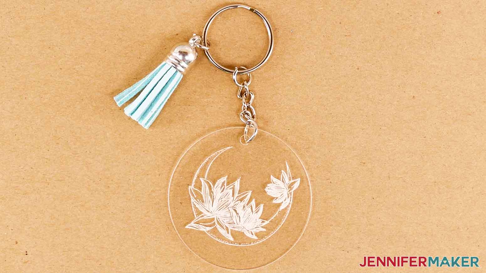 A picture of the final engraved acrylic keychain with a ring and tassel attached.