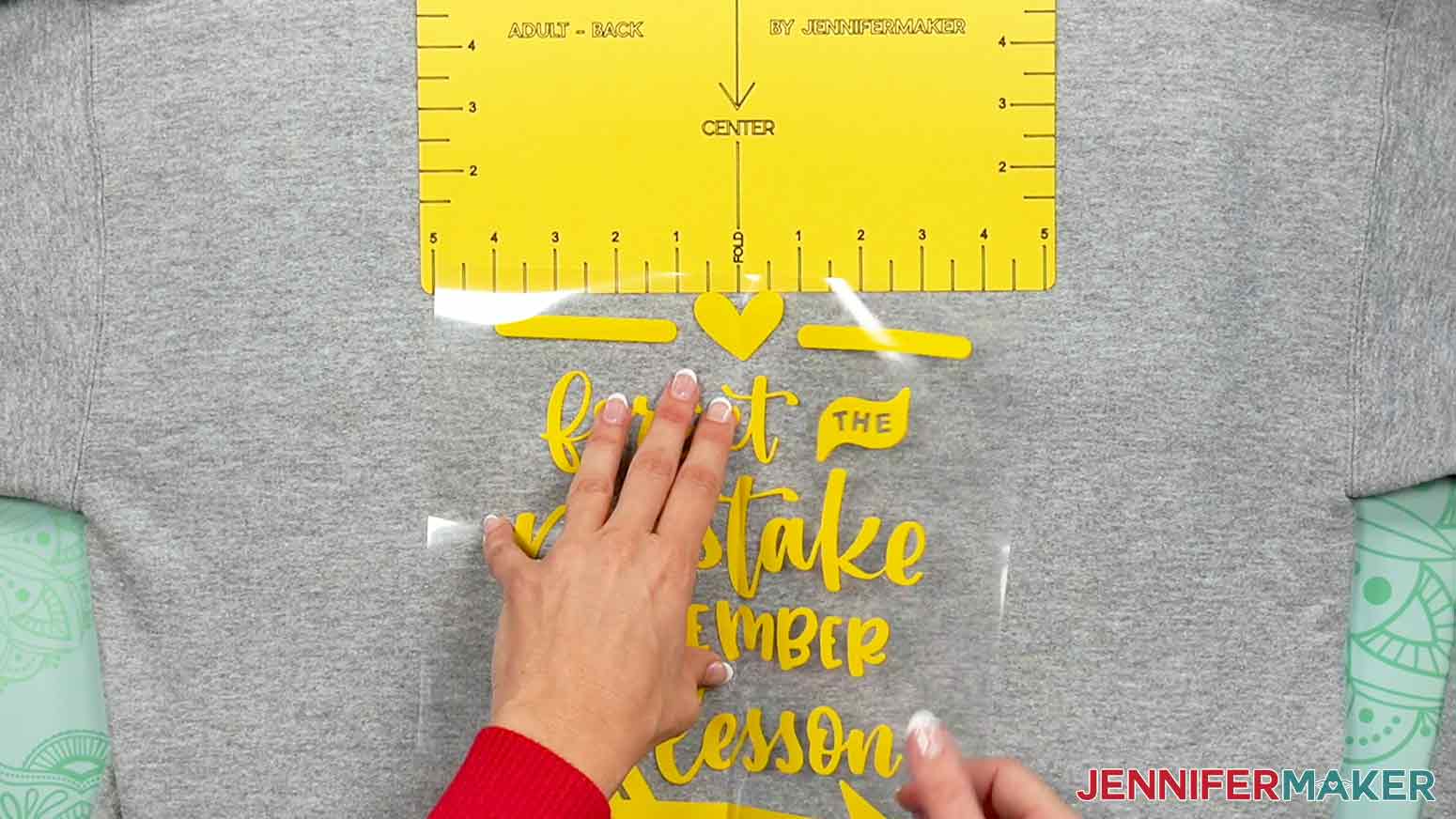 Showing how to align the crease line of the Remember The Lesson decal aligned with the T-Shirt-Ruler with the Adult Back T-Shirt-Ruler.