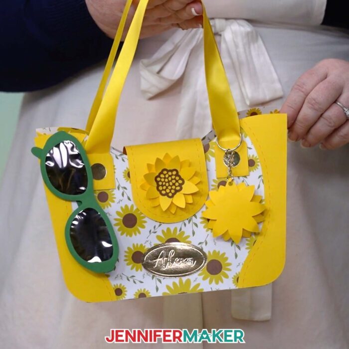 Learn how to make a paper purse with JenniferMaker's tutorial! Jennifer holds the customized large Sunflower 3D paper purse.