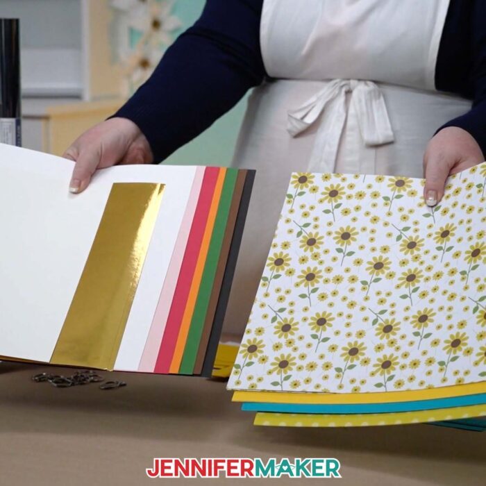 Learn how to make a paper purse with JenniferMaker's tutorial! You'll need cardstock in solid, patterned, and foil varieties to create your 3D paper purse.