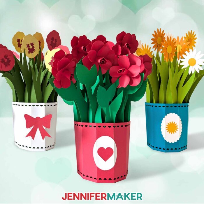 Three cardstock cards with 3D Pop-Up Spring Flowers, one with red and yellow pansies, one with red roses, and one with yellow and white daisies