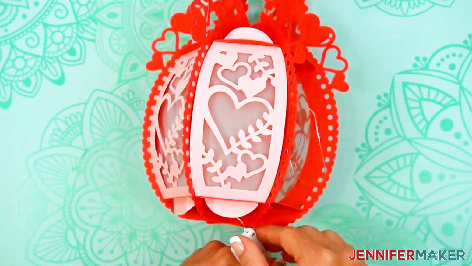 Slide the fairy lights battery pack through a bottom hole in the assembled 3D ornate paper lantern.