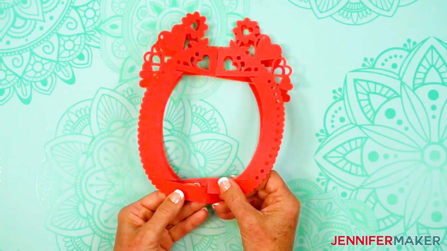 Take the lantern frame piece with a slit at the top of the outer edge and slot it inside the frame piece with slits at the top and bottom of the edges.