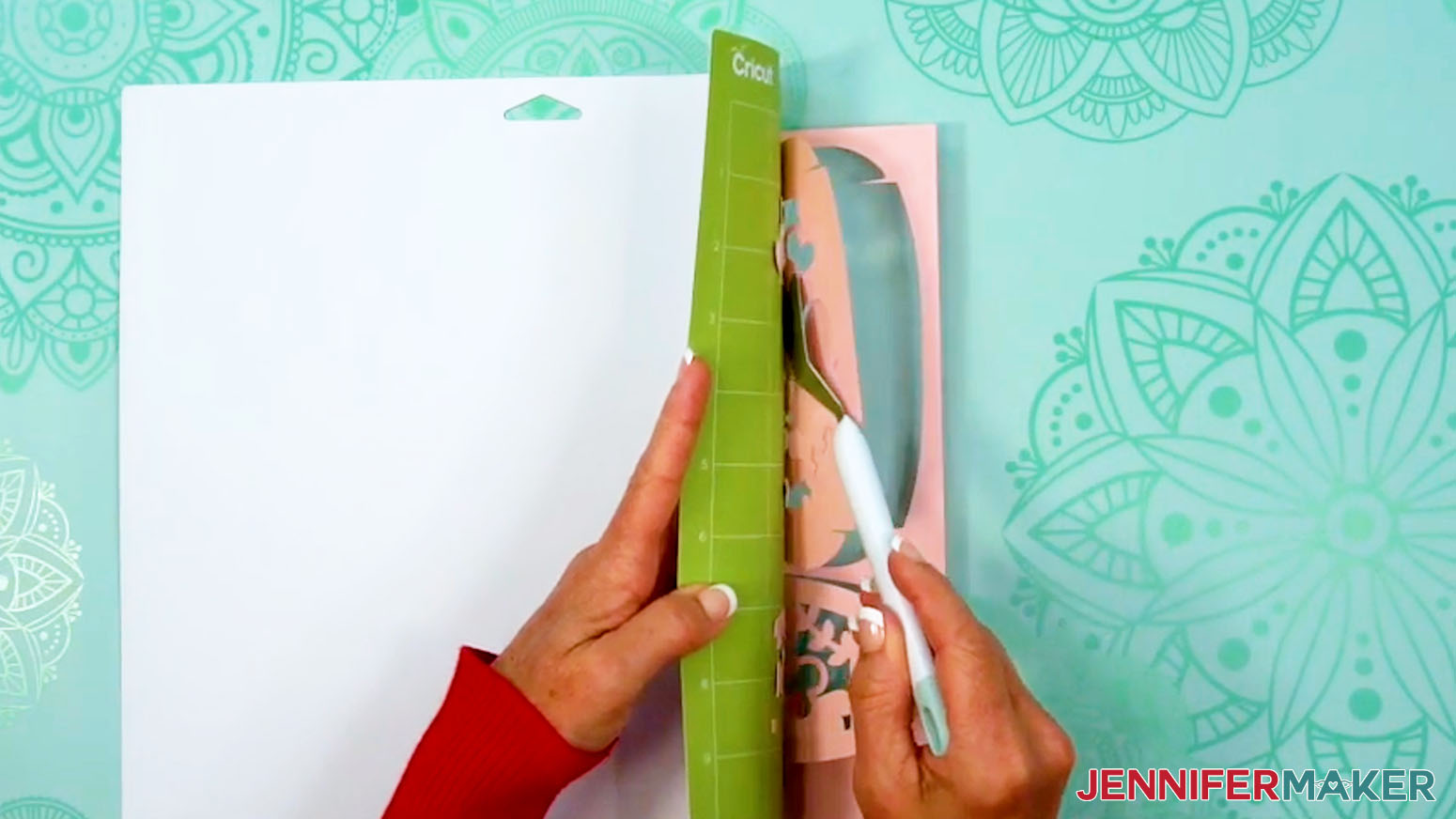Using a Cricut spatula to lift delicate pieces off the machine mat.