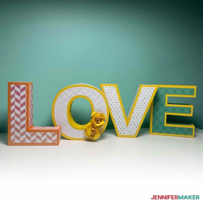 Decorative 3D Paper Letters on a white table spelling LOVE