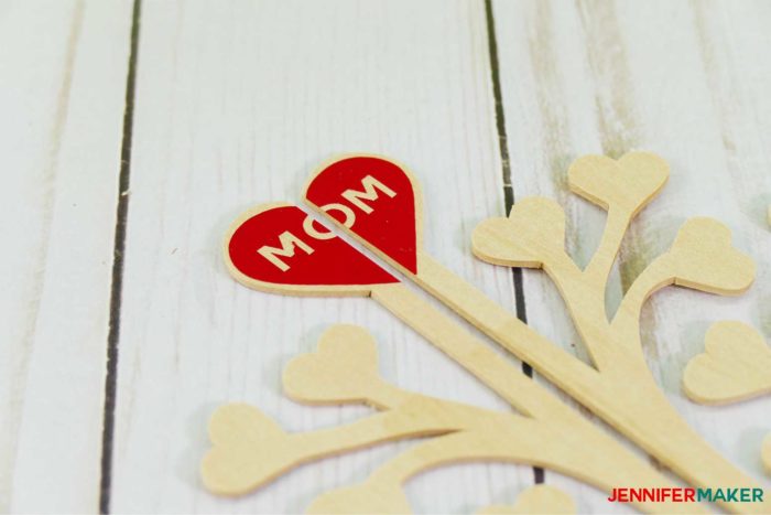 Decorating the 3D family tree with red vinyl for Mother's Day