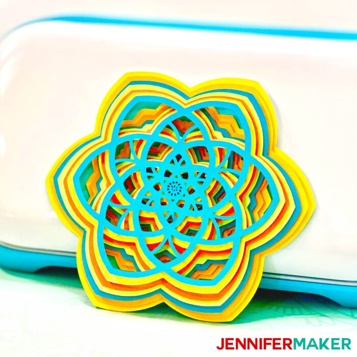 Easy 3d layered mandala shaped like a flower in front of a Cricut Joy