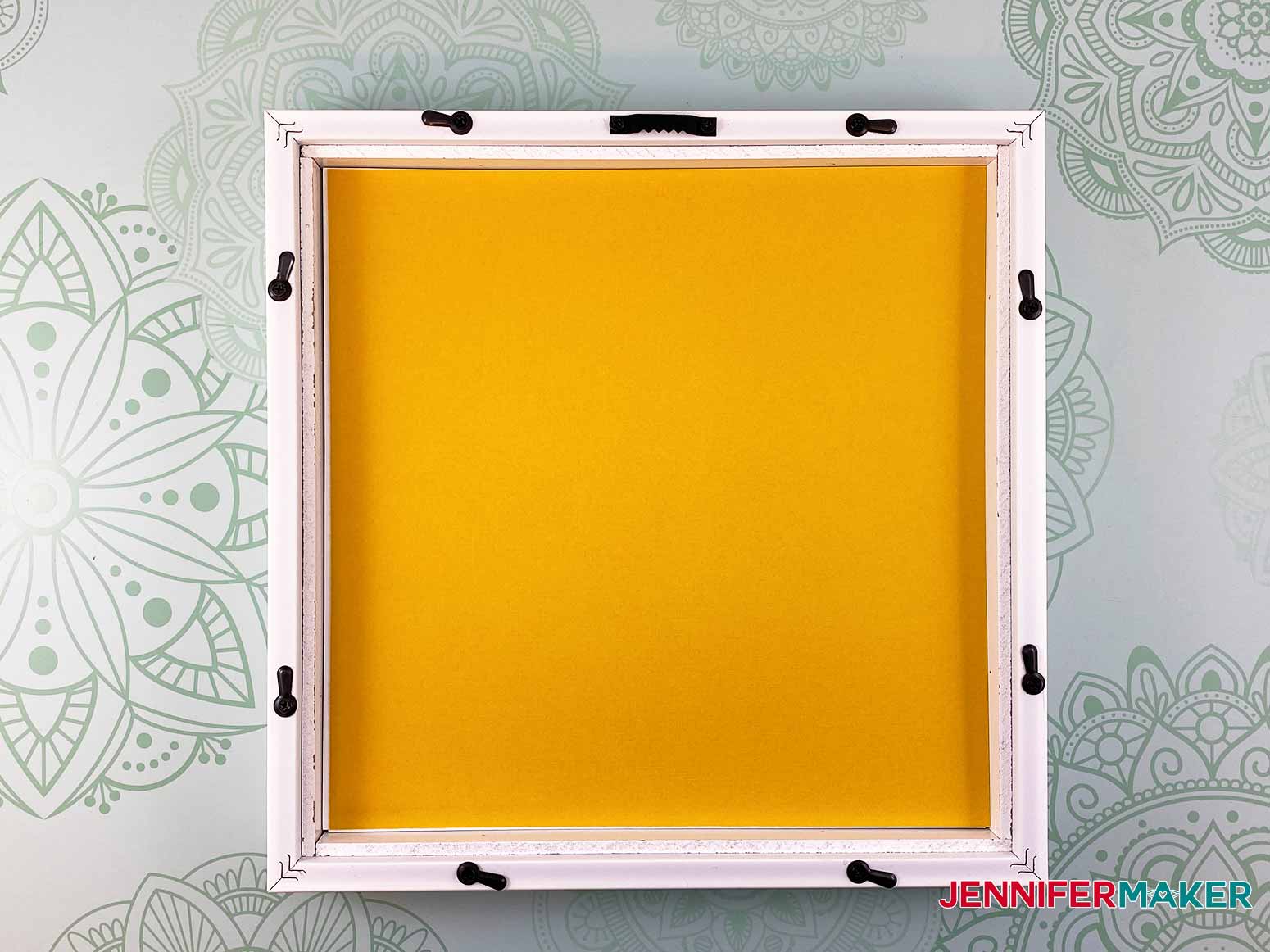 Add a contrasting layer of cardstock on top of the stacked layers in the picture frame for my 3d layered paper cut art project