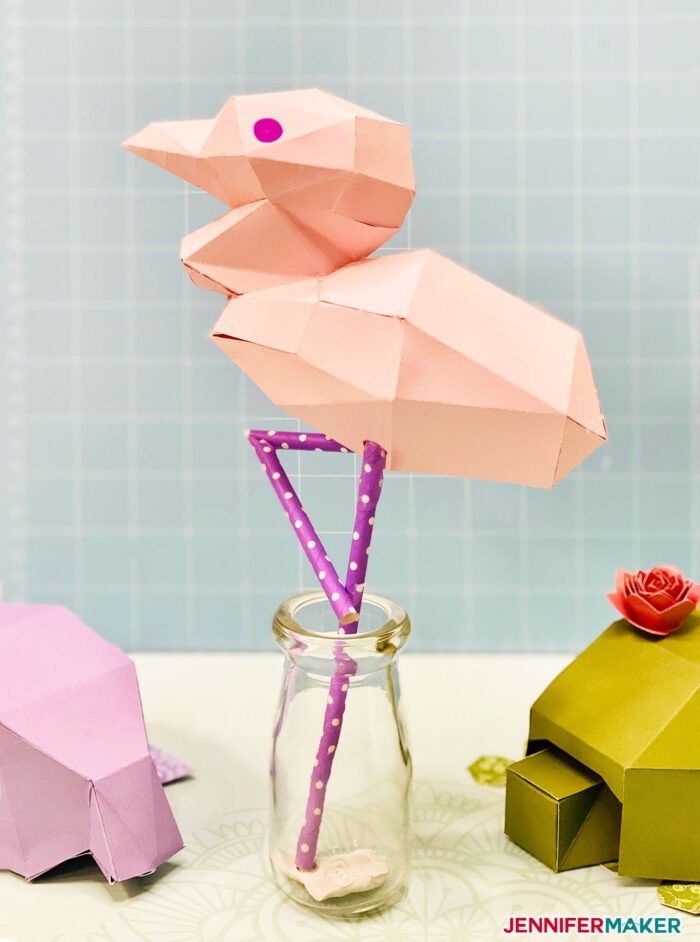 3D paper flamingo papercraft made from pink cardstock and purple polka dot straws