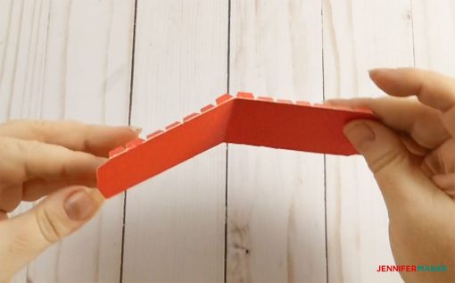 Fold the rectangle in half and all tabs for your 3d paper heart box