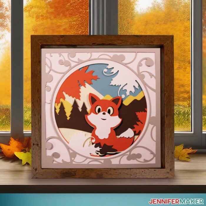 3d layered shadowbox project with fox and fall mountain scene in front of a window showing an autumn day.