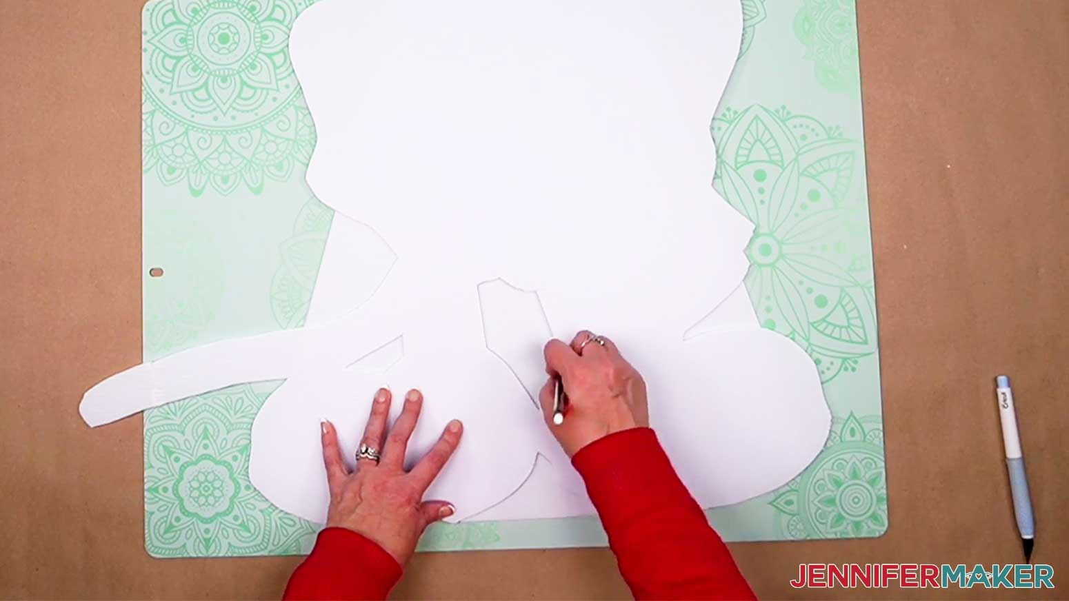 Tracing the gaps and extra openings of your DIY Cut Out Character onto the plastic sheet for a better appearance.