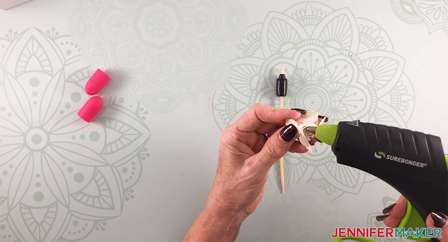 Gluing a paper rose with a DIY quilling tool to make a paper flower shadow box