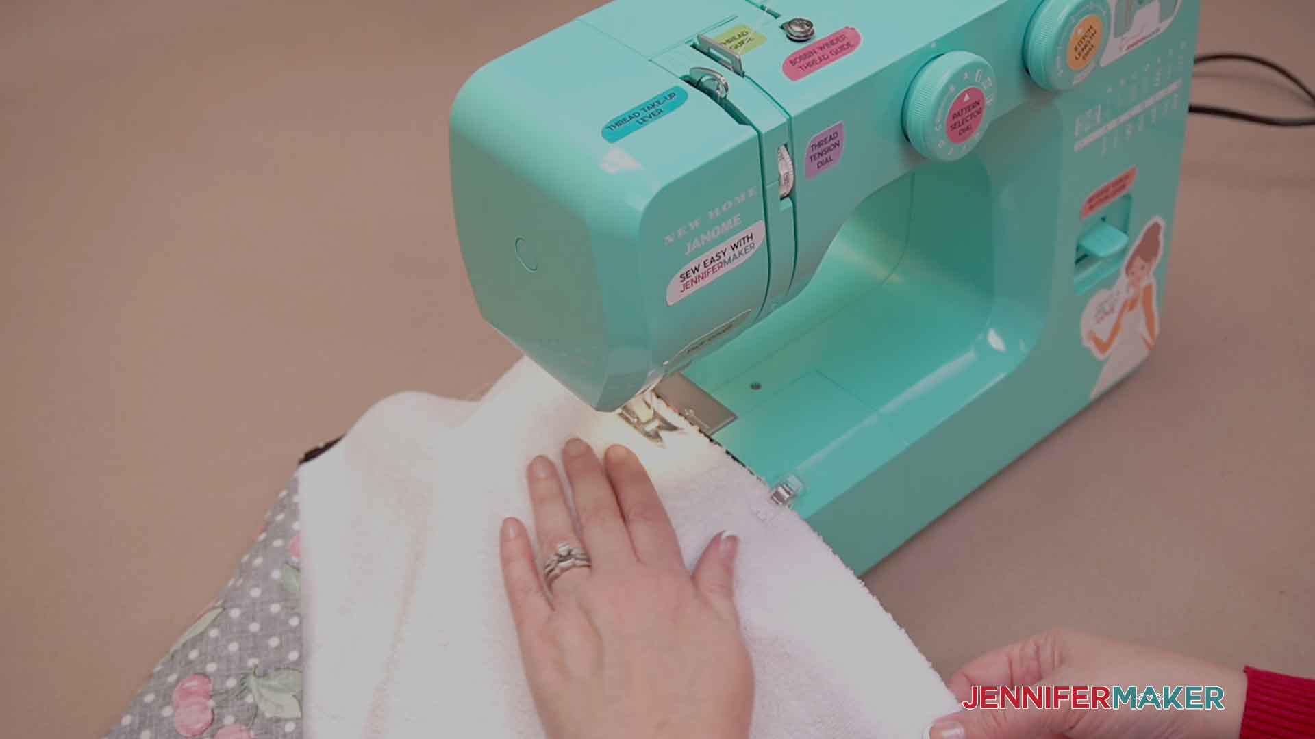 Using my sewing machine to sew the towel to the fabric for my Kitchen Boa pattern.