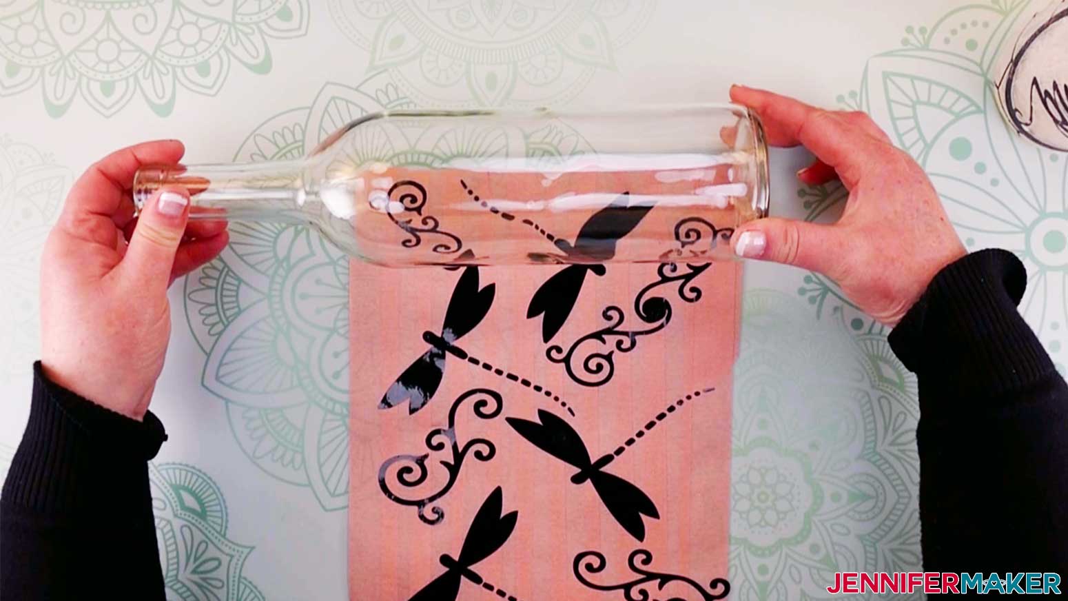Lay your wine bottle on top of the design in order to start applying design to the bottle for my wine bottle art.