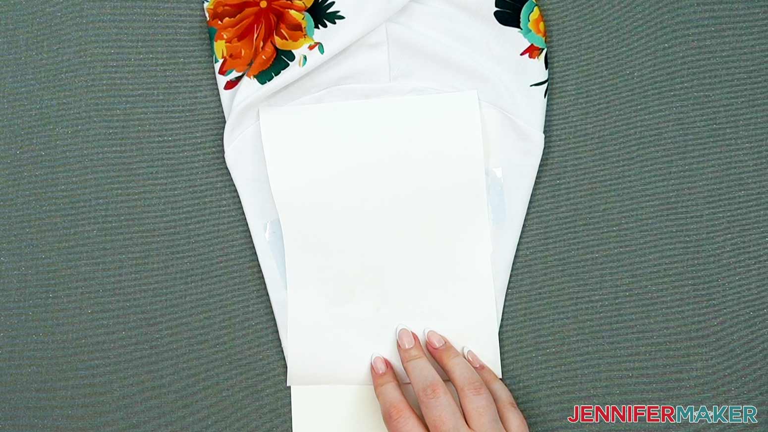 Place a piece of butcher paper on top of the sleeve and taped design.