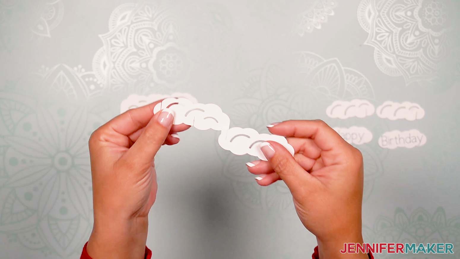Image showing how to assemble the clouds with the slits and tabs for the birthday card pop up.