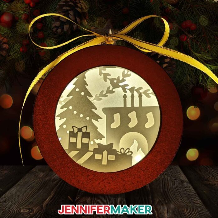 Paper ornament shadowbox with presents, a Christmas tree, and a fireplace with stockings