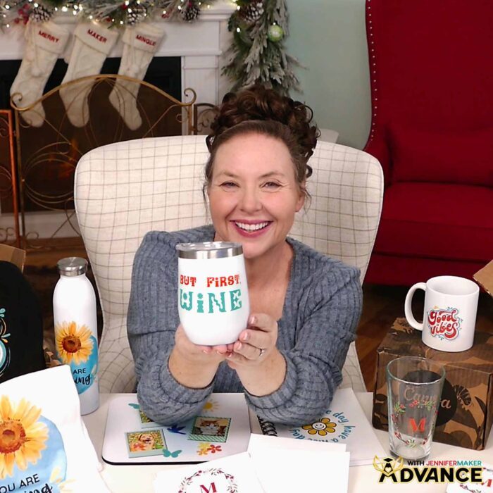 Jennifer shows off her custom wine tumbler with the words "But first, wine" in red and teal lettering.