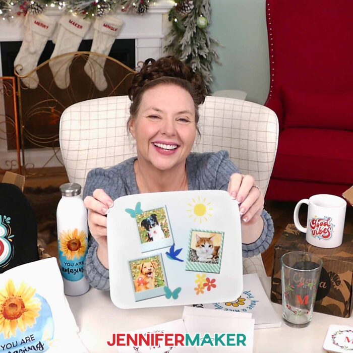 Jennifer holds up a mousepad made in Canva featuring photos of her dogs Hunter and Chloe and her cat Butterscotch.