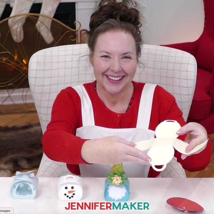 Jennifer Maker sits at her craft table, showing off Curvy Keepsake Boxes and an open box base piece