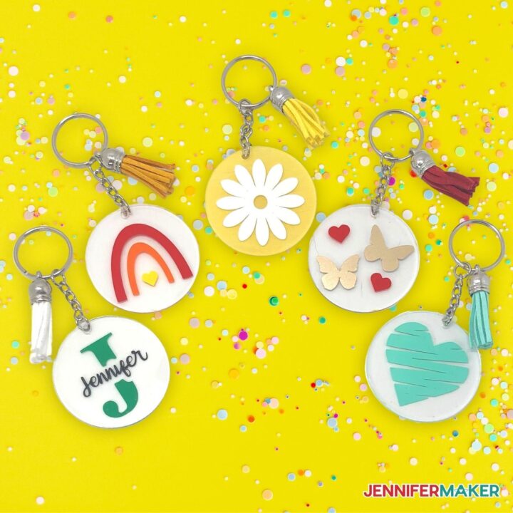 Set of five DIY Acrylic Keychain made using a Cricut cutting machine on a bright yellow background