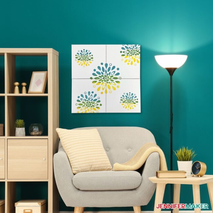 DIY Canvas Wall Art hanging on a teal wall next to a lamp, bookcase, and chair