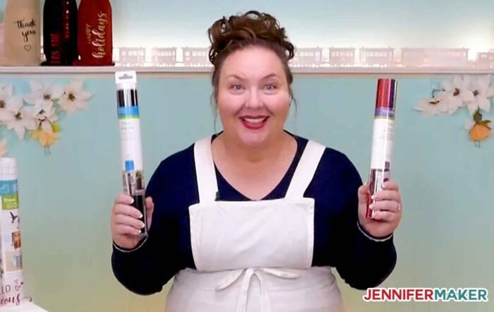 Jennifer Maker holding a roll of permanent vinyl and a roll of iron on vinyl