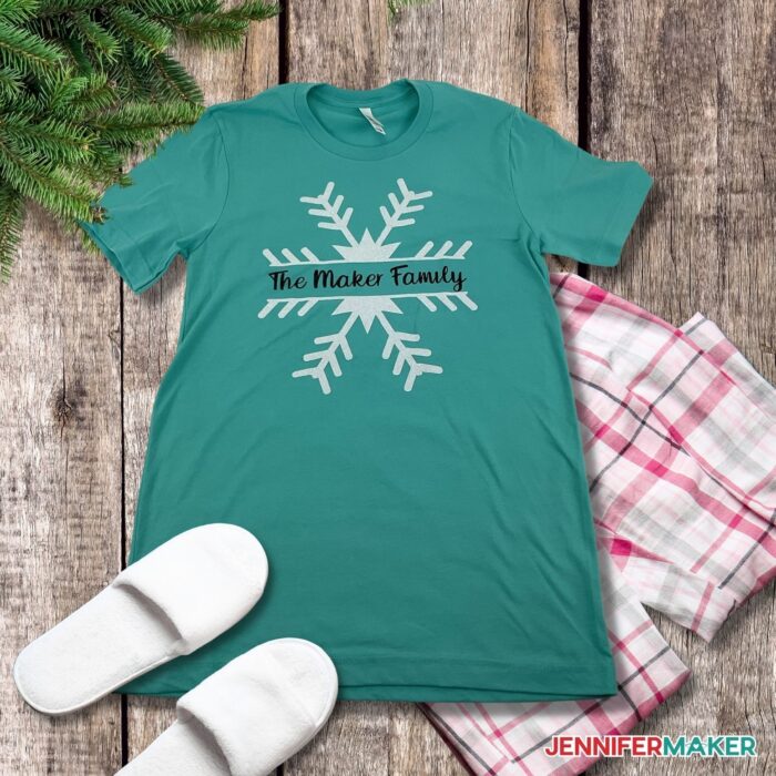DIY custom t-shirt in a teal color with the words "the Maker family" on the surrounded by a big white snowflake