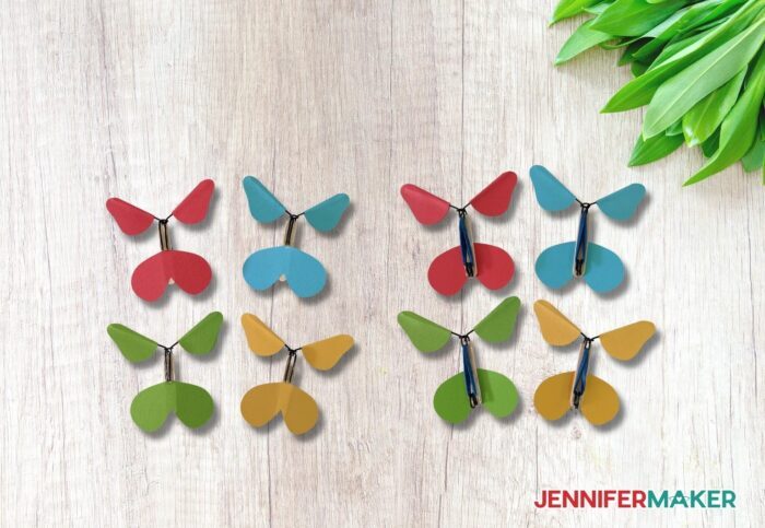 Colorful cardstock spinners made with wire and rubber bands for the DIY exploding butterfly box.