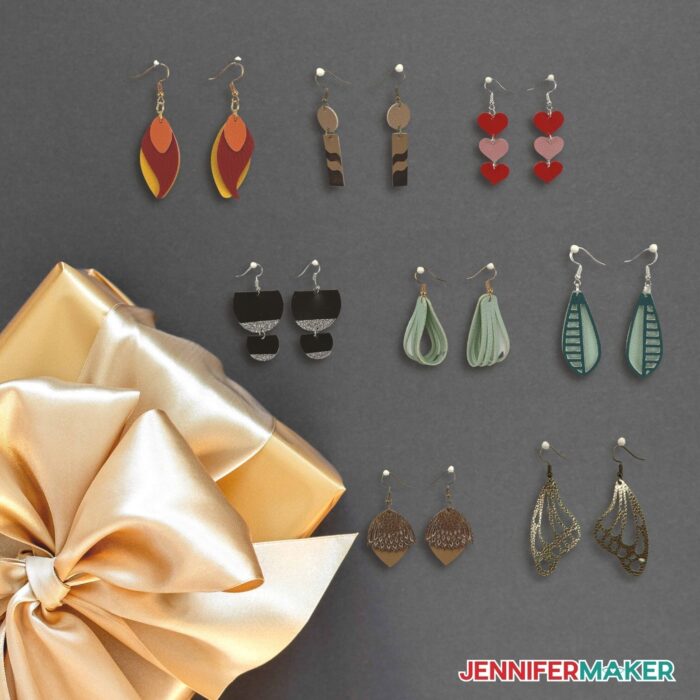 8 Faux leather Earrings on a dark grey background with a gold present beside them