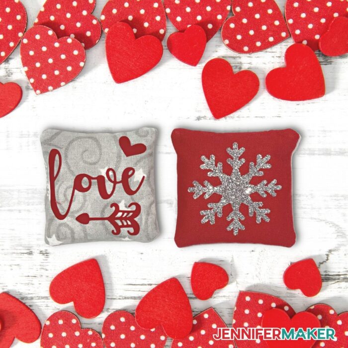 Two DIY Hand Warmers with the words "Love" and a snowflake on them surrounded by red hearts