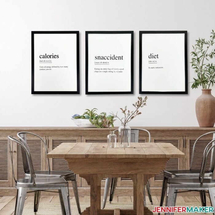 DIY Kitchen Wall Signs hanging on a wall behind a brown table and chairs